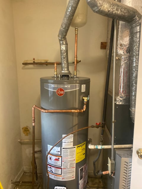 Water heater with copper piping and insulated ductwork in utility room
